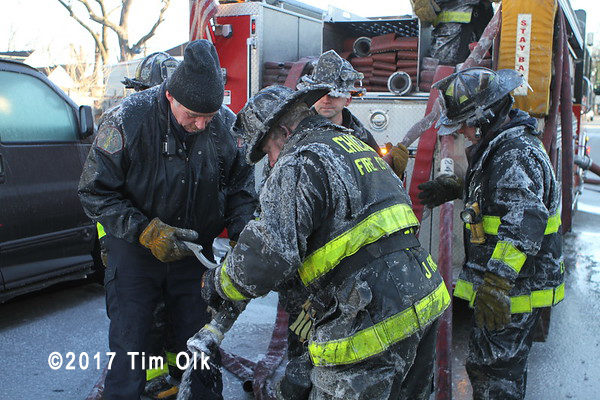 firefighters uncouple frozen hose
