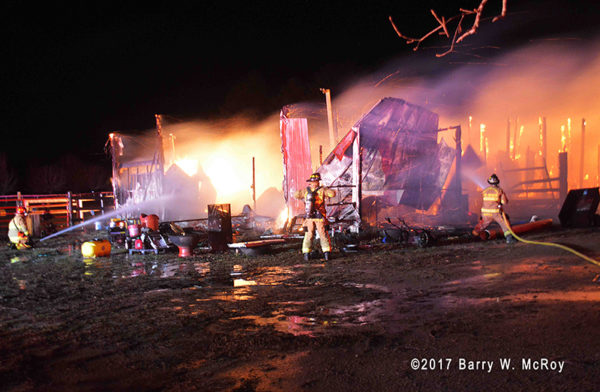 firefighters battle barn fire at night
