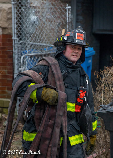 probationary Firefighter carrying hose Chicago Fire Department candidate