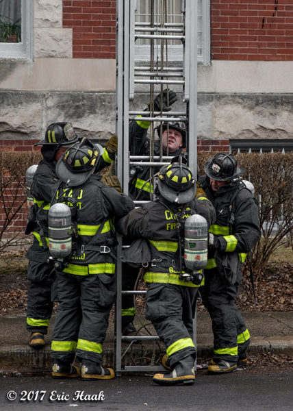 Firefighters raise large ground ladder