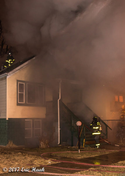 Chicago Firefighters battle a house fire at night
