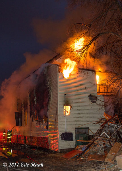 house engulfed in fire at night