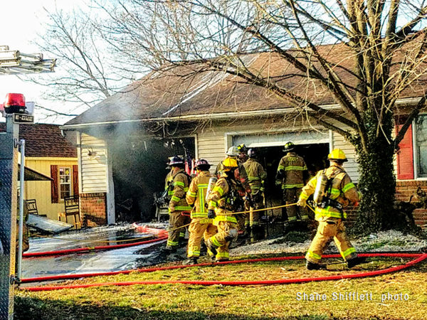 firefighters at garage fire