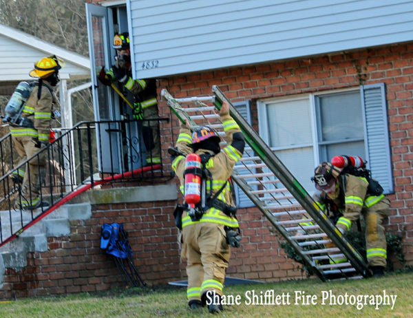 firefighters lower ground ladder