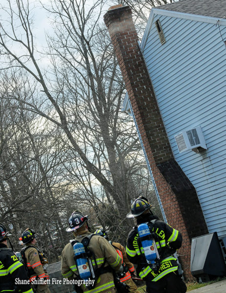 firefighters stand by at chimney fire