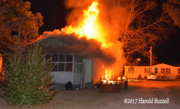 rural house engulfed in flames at night