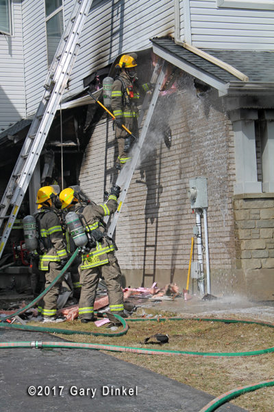 firefighters overhaul after townhouse fire