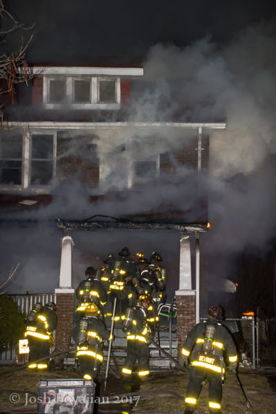Detroit firefighters battle a house fire at night