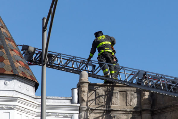 firefighter climbing aerial ladder