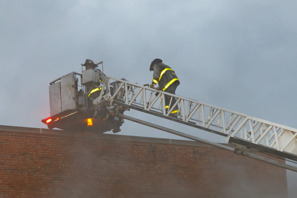 firefighters climb tower ladder