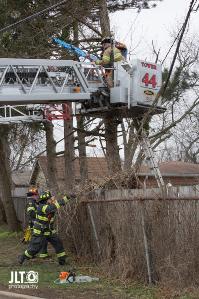 firefighters remove patient in tower ladder platform