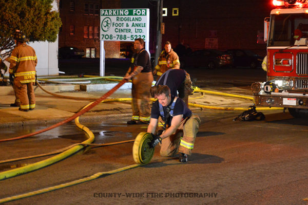 firefighters roll hose after a fire