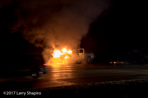 pickup truck engulfed in flames on the highway