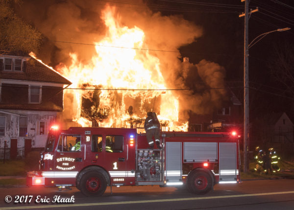 Detroit firefighters battle a house fire with a deck gun