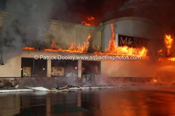 fire engulfs a commercial business at night