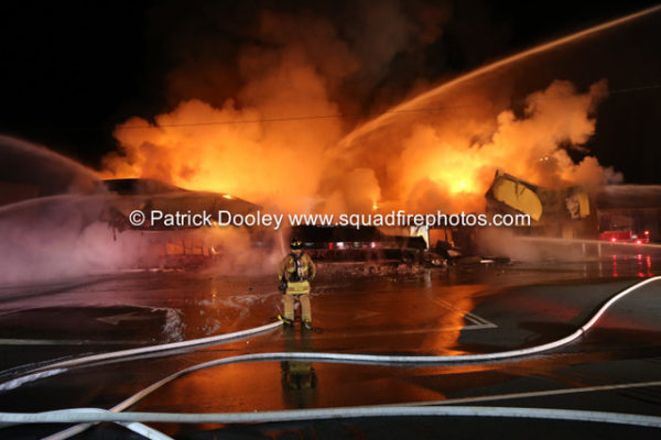 firefighters battle fire that destroyed a commercial business at night