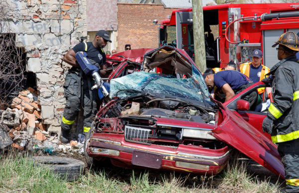 firefighters cut crash victim from car