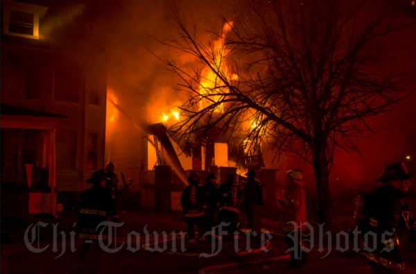 house fully engulfed in flames at night