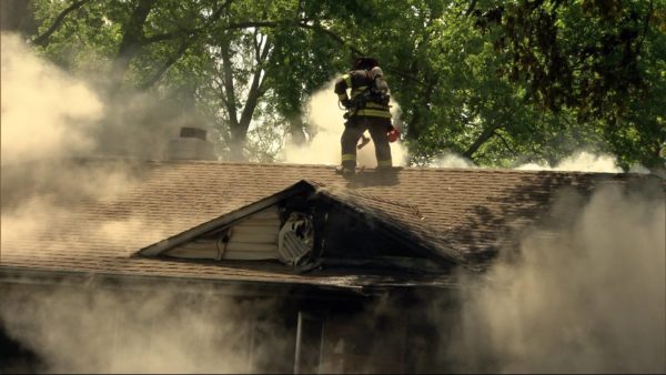 firefighter ventilates roof