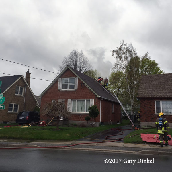 firefighters vent roof at house fire