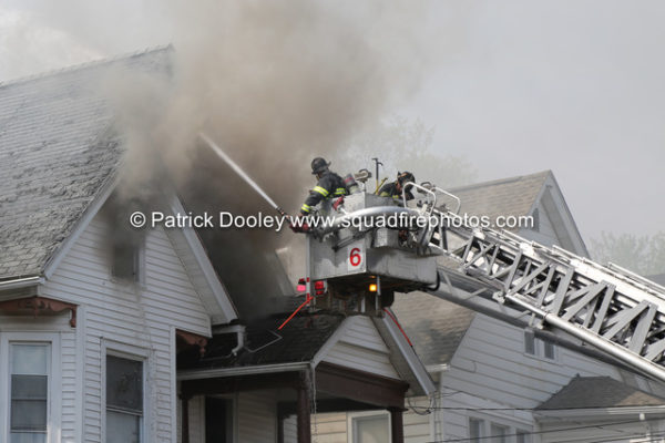 Stuffed tower ladder working during a house fire