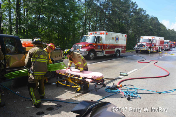firefighter/paramedics with Stryker cot at crash site