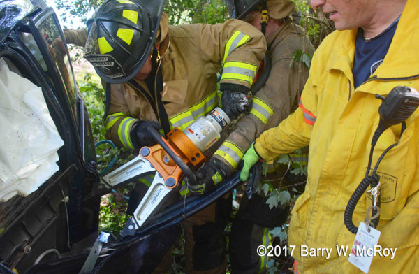 firefighters use Holmatro spreaders at crash site