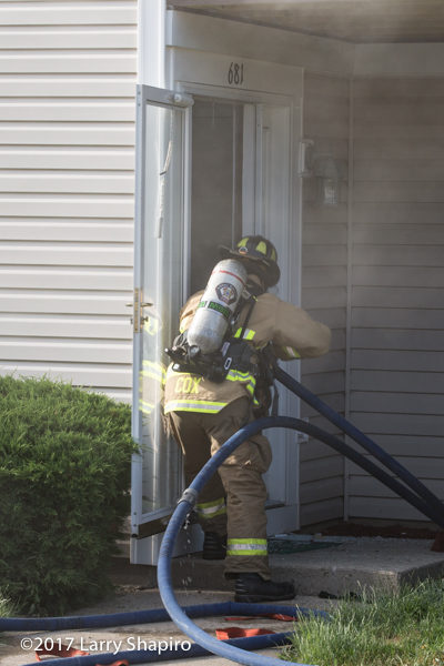 Firefighter makes entry with hose