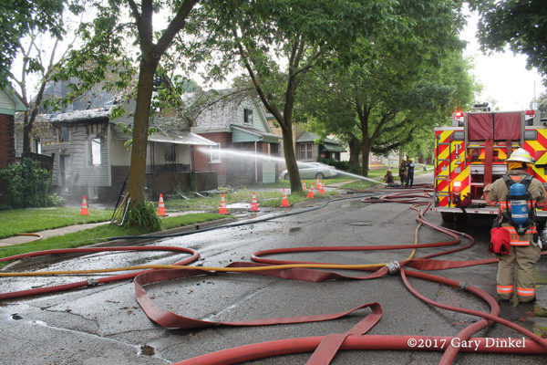 hose in the street after house fire