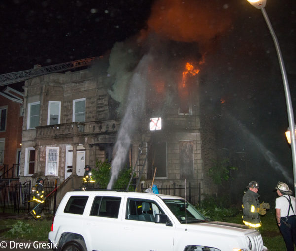 firefighters battle second floor fire at night