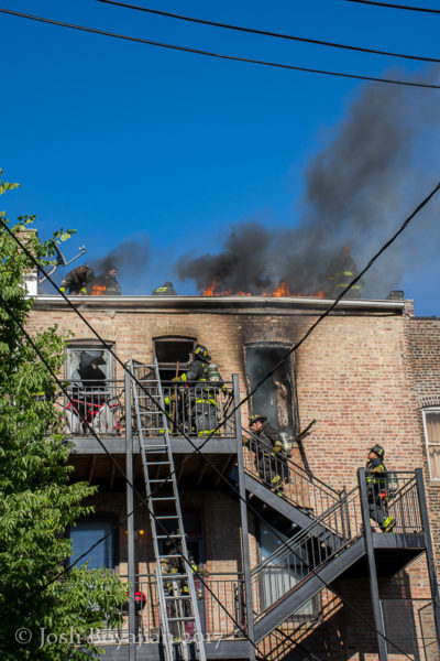 firefighters battle fire at 3-story building