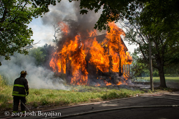vacant house engulfed in flames