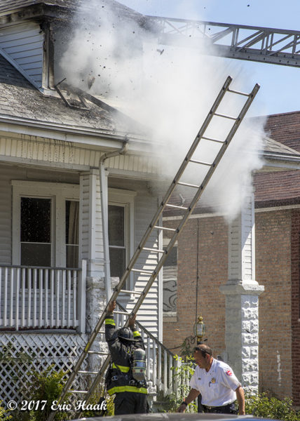 firefighters raising a ground ladder at a fire