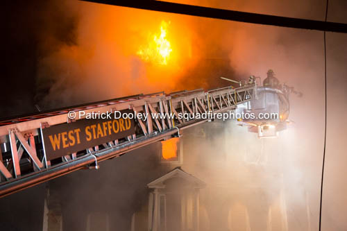 firefighters use a Sutphen tower ladder at a fire