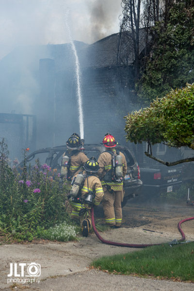 firefighters with hose line
