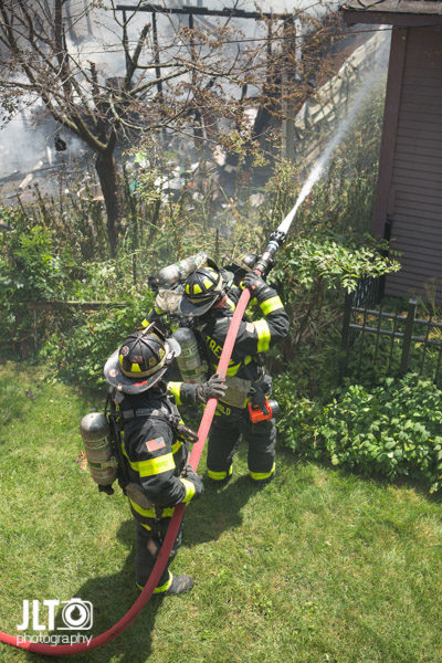 firefighters with hose line