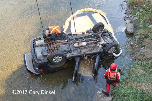 tow truck lifts car from water