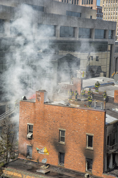 Firefighters vent apartment building roof