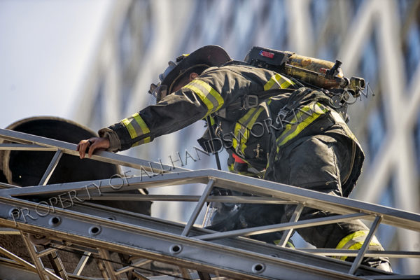Firefighter climbs aerial ladder