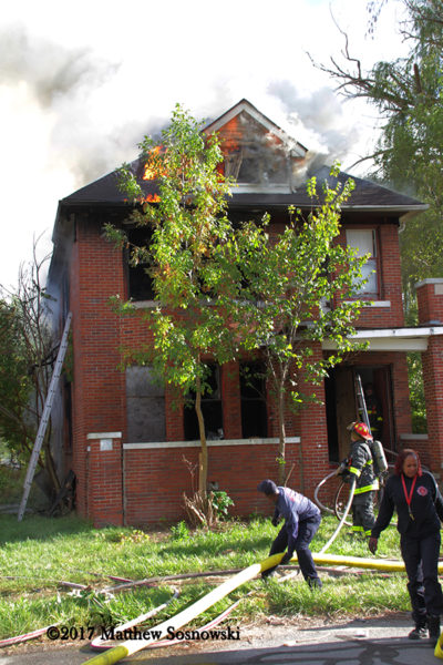 Detroit Firefighters stretch on a vacant dwelling
