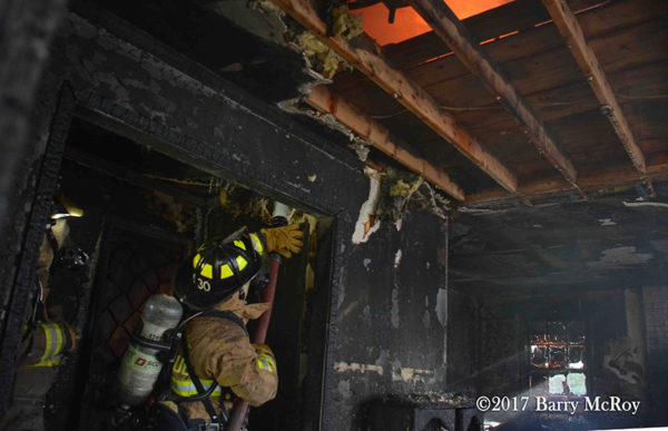 Firefighters overhaul after a house fire