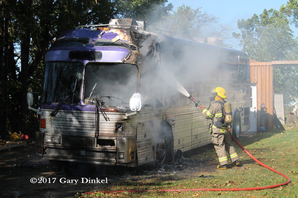 Firefighter battles tour bus fire