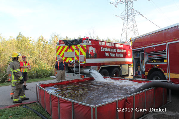 fire department tanker dumps into portable tank