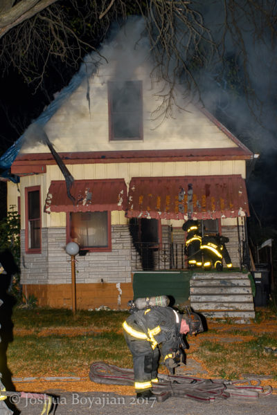 Detroit firefighters make entry into a burning house