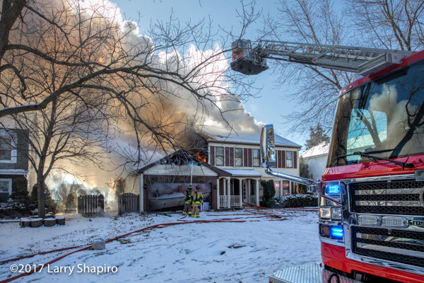 smoke and flames from house on fire in the winter