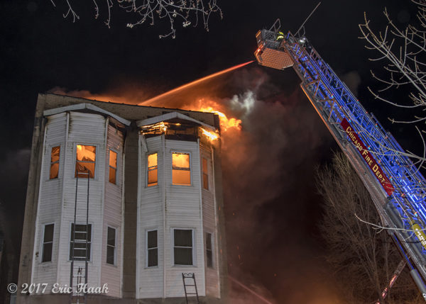 tower ladder battles fire at night