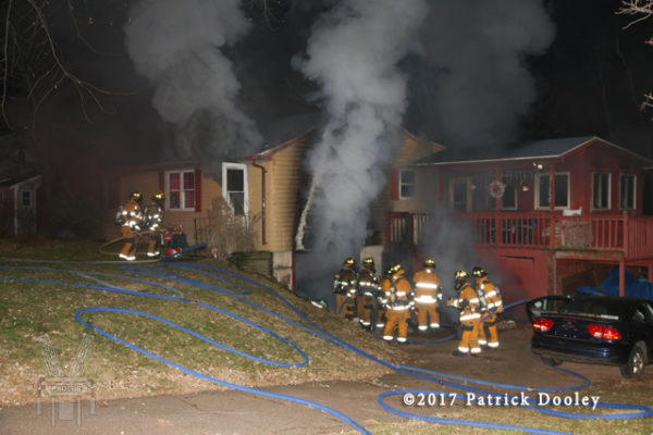 firefighters battle a basement fire