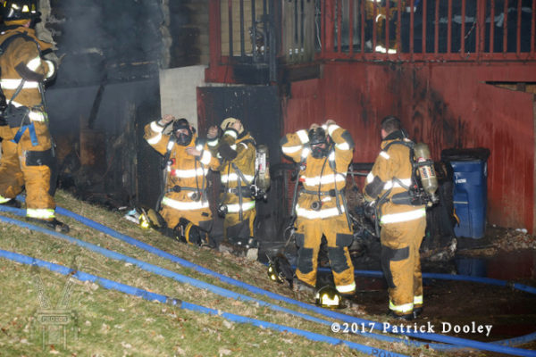 firefighters mask up at fire scene