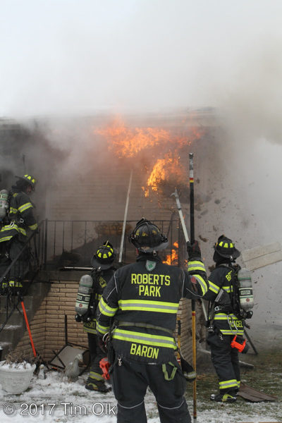 firefighters pull soffit with flames