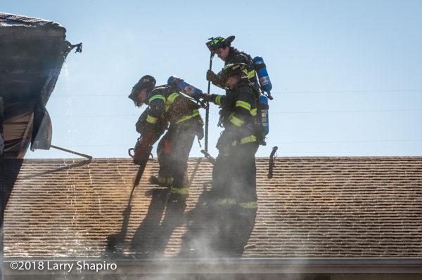 firefighters vent roof with a saw